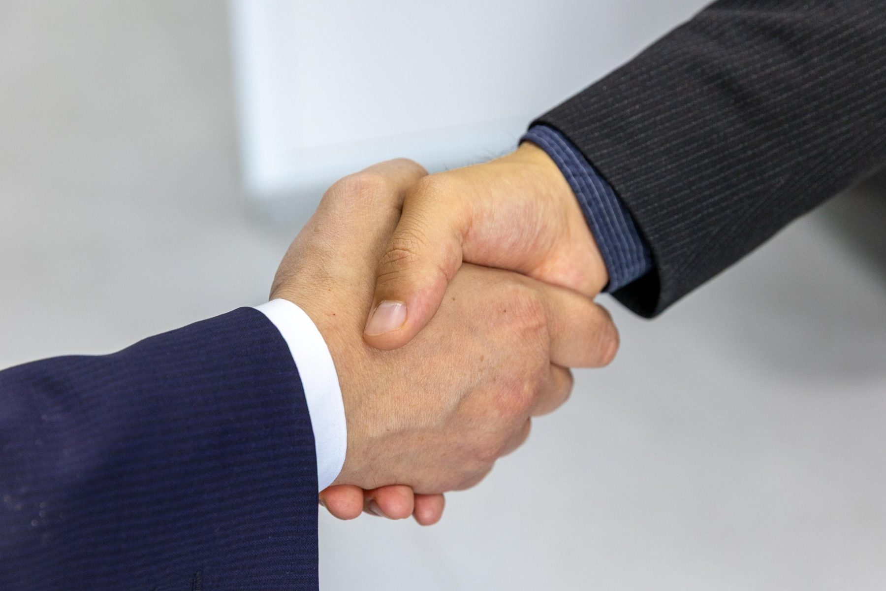 Two people shaking hands to agree a deal